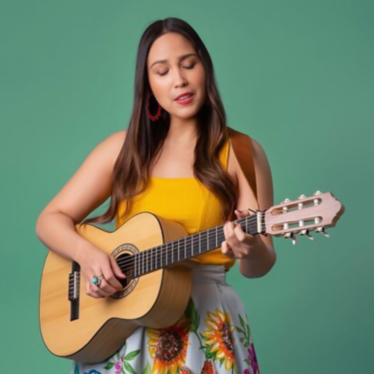 Sonia De Los Santos playing guitar